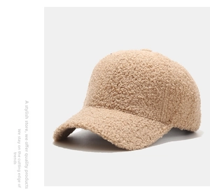 Close-up of thick beige lambswool texture and seam detail on a soft winter baseball cap