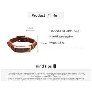 Detail of vintage brown leather bracelet with engraved alloy plate and buckle closure