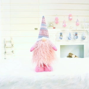 Close-up of a pink plush gnome featuring a knitted pointed hat and soft faux fur beard