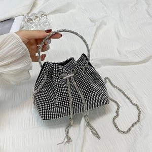 Minimalist black rhinestone bucket bag with silver metal handle and chain crossbody strap