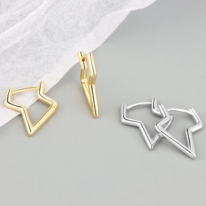 Minimalist geometric star-shaped hoop earrings in polished gold and silver metal finishes