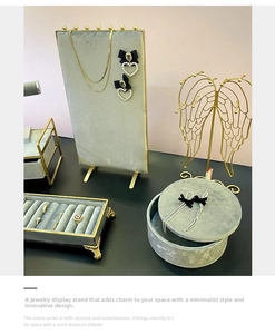 Detailed set of velvet jewelry display stands with gold metal wing rack and ring trays