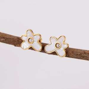 Cloud pearl earrings with gold trim and white petals on a natural branch