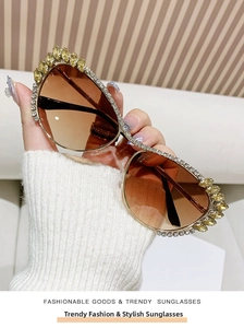 Detail of oversized teardrop sunglasses with rhinestones and yellow crystal embellishments