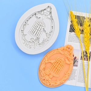 Silicone mold for birdcage and rose relief pendant with finished orange aroma candle