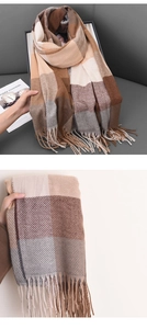 Detail view of British style cashmere-like scarf with plaid pattern and classic fringes