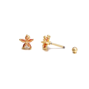 Detail of gold star earring with red marquise gemstones and secure screw back closure