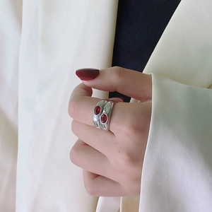 Macro view of vintage silver ring featuring dual oval red ruby stones and wide band