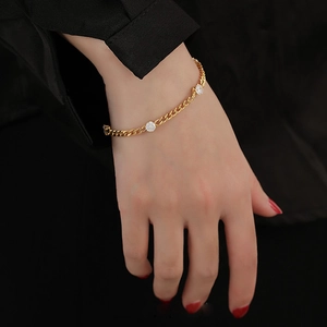 Fashionable titanium steel Cuban chain bracelet with round white gemstones worn by model