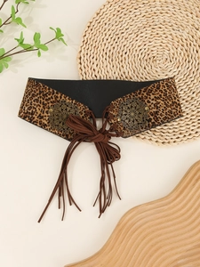 Detail of leopard print waist belt featuring brown tassels and vintage metal buckles