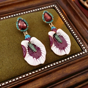 Close-up of vintage floral earrings with colorful enamel and sparkling rhinestones