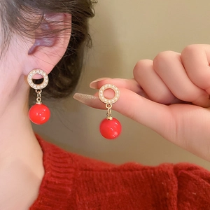 Vintage geometric gold earrings with red pearls and crystals worn on model