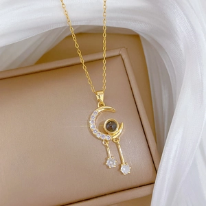 Detailed macro view of a gold moon necklace with sparkling diamonds and star pendants