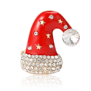Sparkling rhinestone Christmas hat brooch with red enamel and gold plating on white background