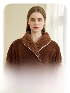 Detail of dark brown plush robe featuring textured wheat ear collar and white piping trim