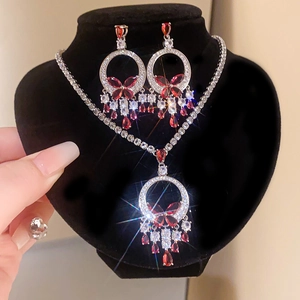 Luxury silver bridal jewelry set with sparkling red gems and bow tassel necklace