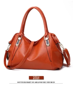 Detailed view of the large capacity soft leather shoulder bag in yellow-brown finish