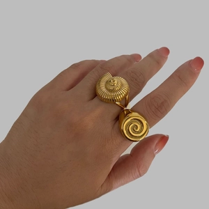 Vintage gold conch and spiral hollow stainless steel rings set for women displayed on hand