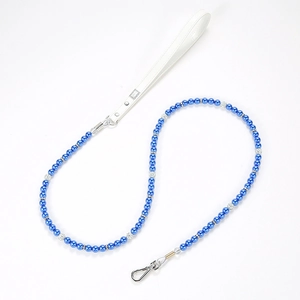 Detail of luxury deep blue pearl pet leash with white leather handle and silver metal clasp