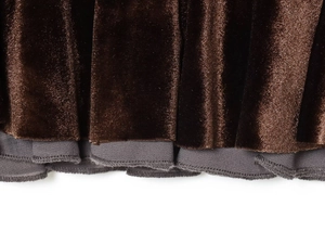 Detail of premium brown velvet fabric with gray piping texture and elegant sheen