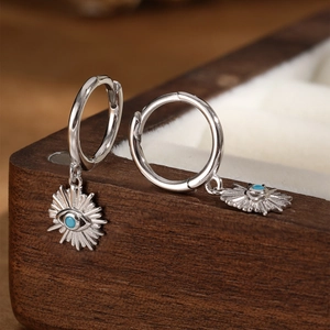Detailed close-up of S925 sterling silver evil eye hoop earrings with blue center stone