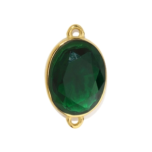 Macro view of emerald green oval zircon pendant with dual golden connection rings