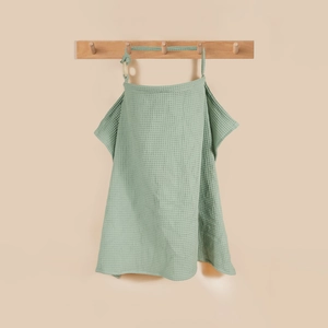 Close-up of mint green waffle cotton nursing cover with adjustable wooden buckle ring
