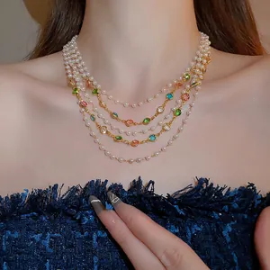 Elegant layered pearl necklace with colorful gemstones on a gold chain for women