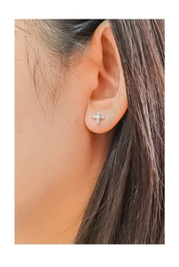 Close-up of minimalist S925 sterling silver cross stud earrings with sparkling zircons