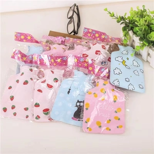 Flat lay of mini hot water bottles with various cute cartoon patterns and PVC texture