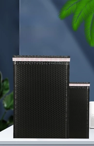 Detailed view of heavy-duty black bubble mailers with self-sealing adhesive strips