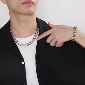 Silver cuban link necklace and bracelet set for men worn on a casual outfit
