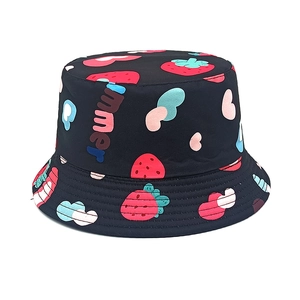 Close-up of black bucket hat with strawberry heart prints and Summer lettering