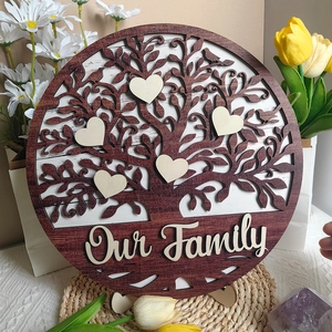 Macro shot of family tree wooden ornament with Our Family engraving and heart charms