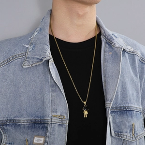 Collier avec pendentif astronaute doré en acier inoxydable porté sur veste en jean