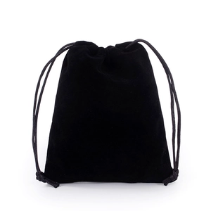 Detail of soft black velvet texture and drawstring closure on a jewelry storage pouch