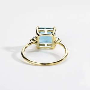 Elegant S925 silver gold ring featuring a square blue gemstone with side stones