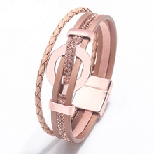Detail of rose gold multi-layer leather bracelet with rhinestone charms and magnetic clasp