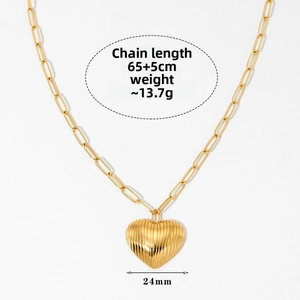 Detail of golden heart pendant with vertical texture and adjustable chain length