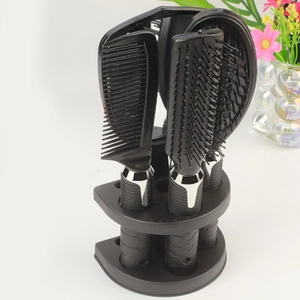 Detail of 4-piece black hairbrush set with stand showing ergonomic anti-slip handles