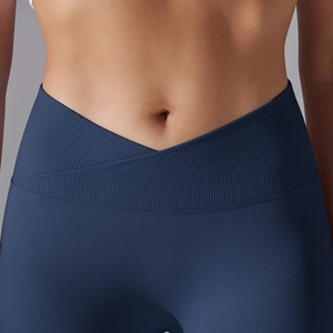 Close-up of seamless dark blue yoga leggings with a V-shaped crossover ribbed waistband
