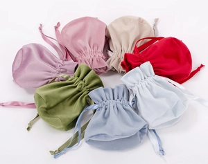 A colorful variety of soft velvet drawstring bags for jewelry storage on white backdrop