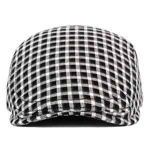 Detail shot of vintage black and white checkered flat cap with textured fabric