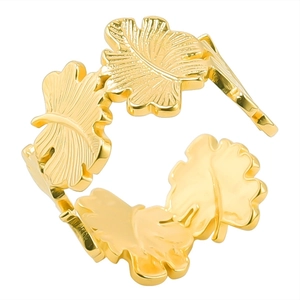 Detailed macro view of the golden leaf-shaped stainless steel open ring with metal texture
