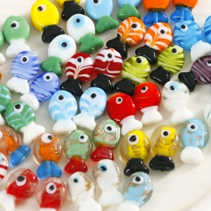 Macro shot of colorful glass fish charms for DIY jewelry making with stripe details