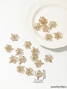 Detail view of 20pcs gold hollow star pendants with cubic zirconia, size 1.5cm x 2cm