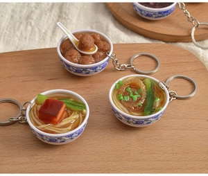 Macro shot of miniature Chinese food resin models in faux blue and white porcelain bowls