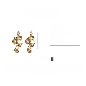 Detail of long gold petal earrings showing 12cm length and 2.5cm width dimensions