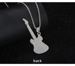 Detail of guitar pendant back showing polished silver steel with grid texture