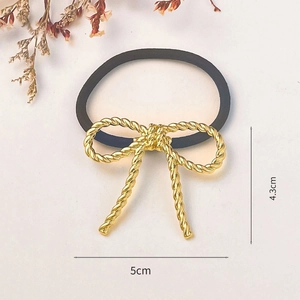 Golden knot bow hair tie with black elastic band, stylish hair accessory for women
